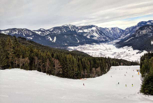 Skiing in the Austrian Alps, Dachstein West, Austria Unidentifiable people skiing down groomed slopes at a ski resort in Dachstein West, Austria, 27 December, 2017 dachstein west photos stock pictures, royalty-free photos & images