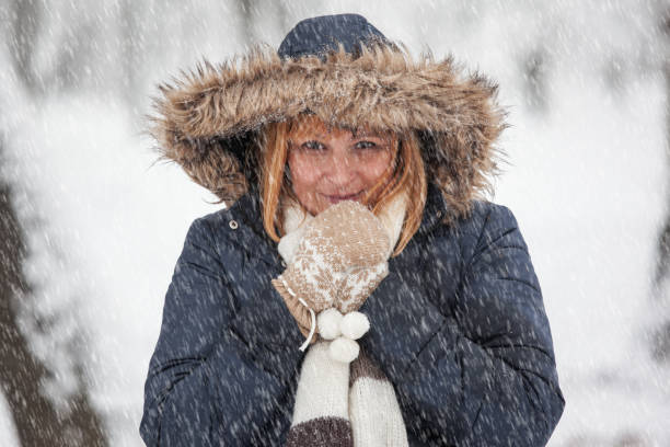 istock Beautiful woman posing outdoor while snowing 899438198