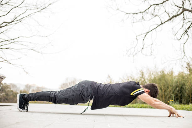 istock Young Adult Doing a Push-up with Arms Stretched Forward 899438494