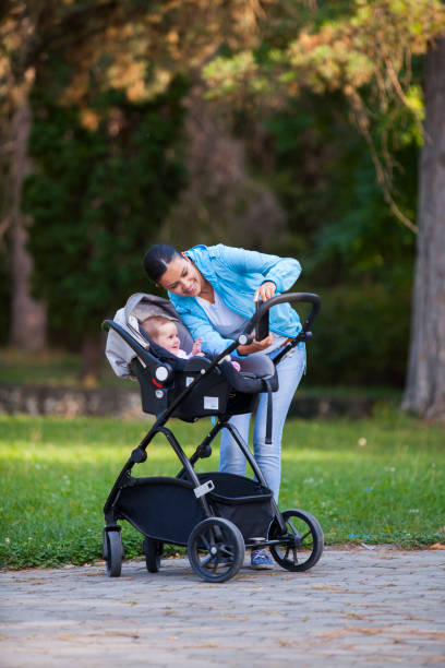 istock baby and mother in park 899447242