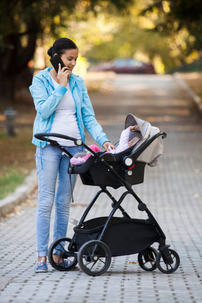 istock baby and mother in park 899450612