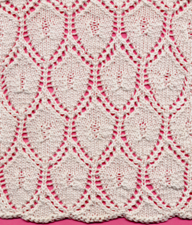 Knitted lace ground in a medallion or shield pattern.