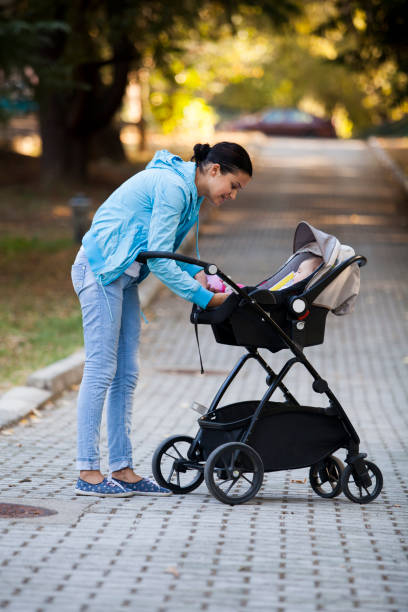 istock baby and mother in park 899451128