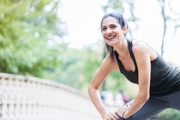 istock Happy woman stretches before outdoor workout 899457910