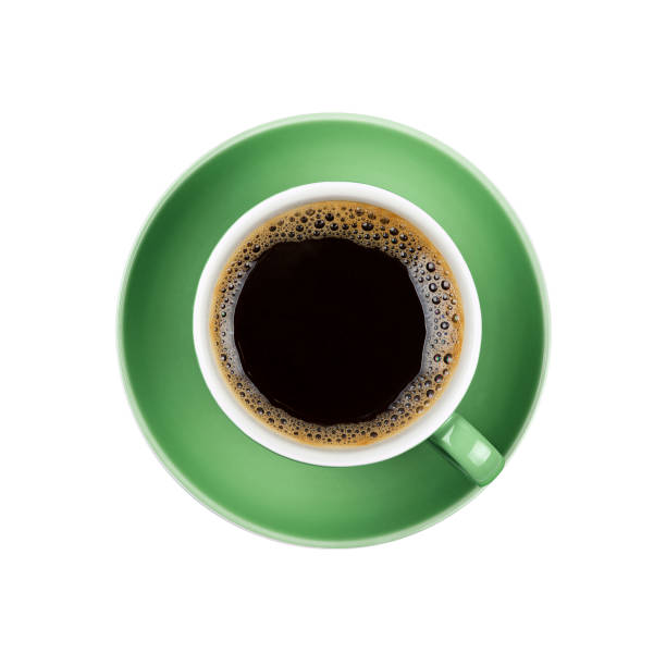 Full black coffee in green cup close up isolated Full cup of black Americano or instant coffee on green saucer isolated on white background, close up, elevated top view black coffee photos stock pictures, royalty-free photos & images