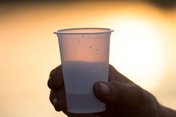 istock glass in hand at sunset 899469086