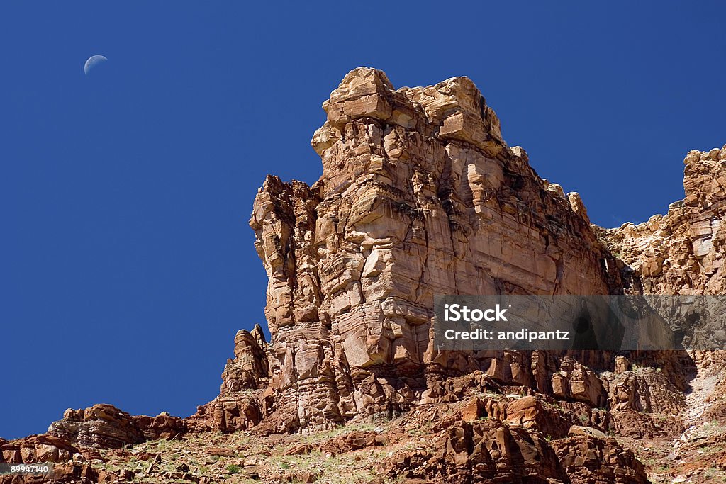 Moon Over the Desert Desert rock formations with the moon in the background. Arid Climate Stock Photo