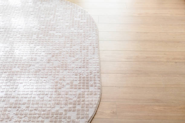 istock Beige soft carpet on laminate parquete floor 899471622