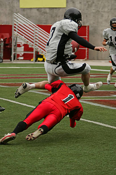 istock Football Running Back Hurdles Defender for Touchdown 89947232