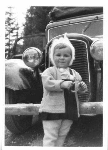 A father and one year old daughter posing in from of a car on Easter Sunday 1962.