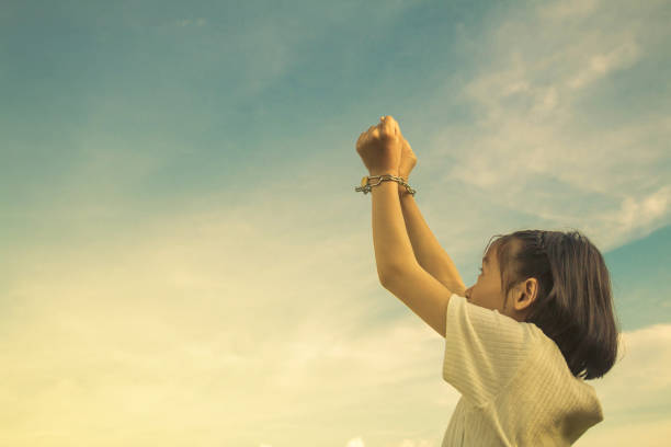 istock Girl Handcuffs Against Cloudy Sky 899476224