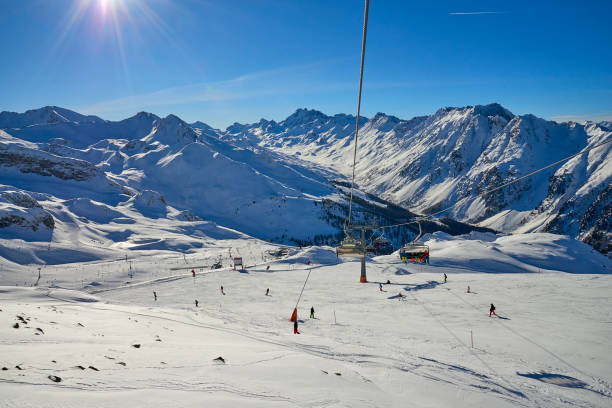Winter resort and ski slopes between mountains on the background