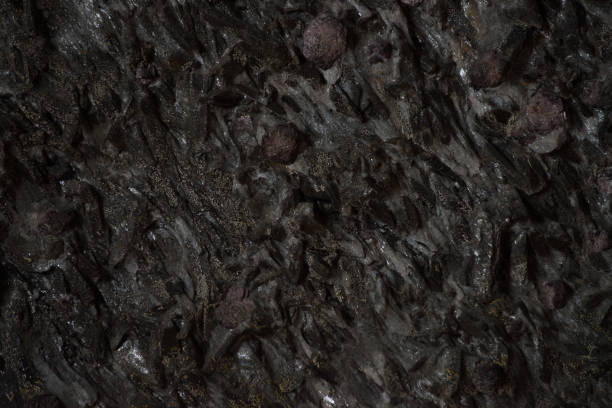 istock Natural black stone texture closeup, dark grey wall background 899483854