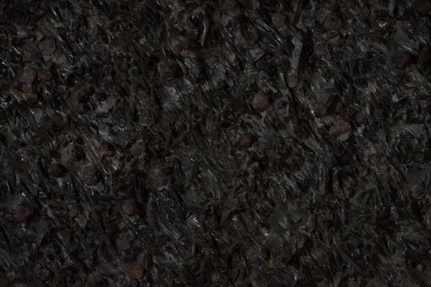 istock Natural black stone texture closeup, dark grey wall background 899483932