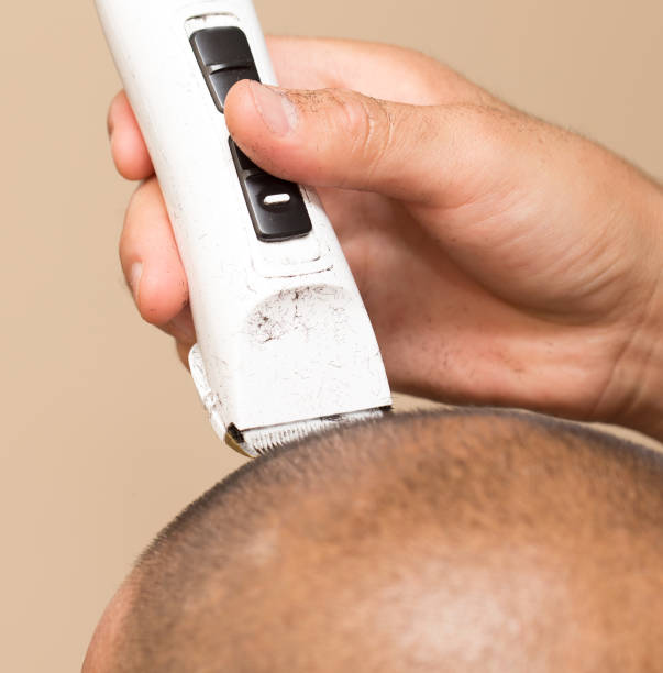 istock Man having a haircut with a hair clippers 899489382
