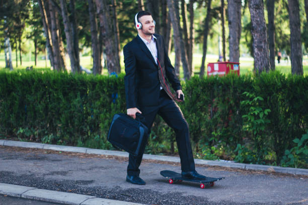 istock Young businessman are going to work with skateboard. 899498574