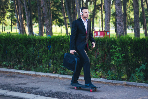 istock Young businessman are going to work with skateboard. 899498742