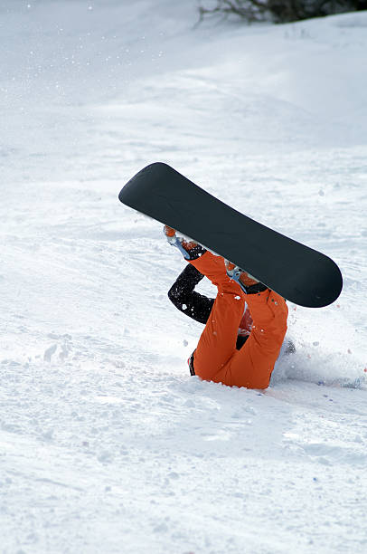 Snowboarder fall stock photo