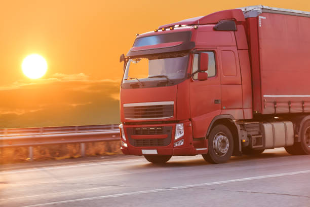 istock truck goes on highway on sunset 899502014