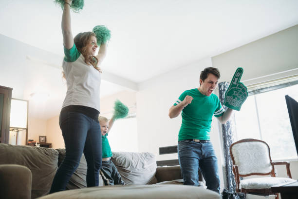 Family Cheering While Watching Football Game