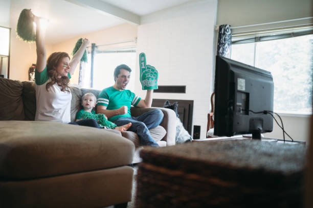 istock Family Cheering While Watching Football Game 899502228