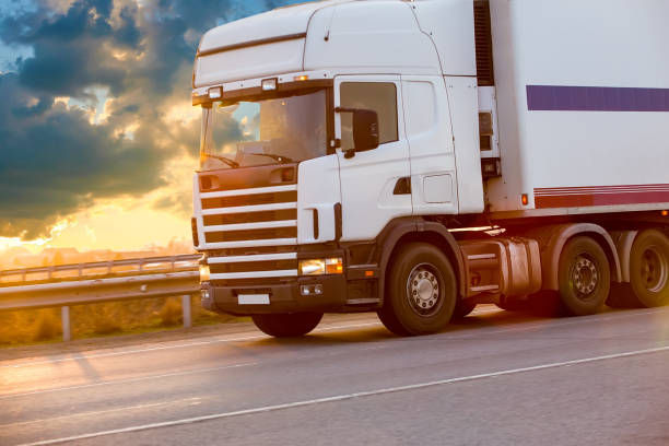 istock truck goes on highway on sunset 899503040