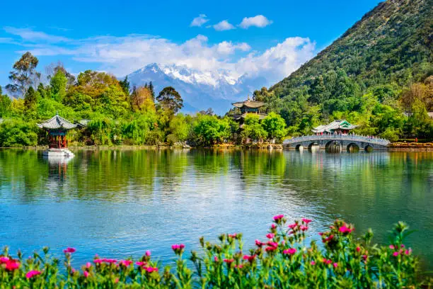 Black Dragon Pool and Jade Dragon Snow Mountain. It's a famous pond in the scenic Jade Spring Park (Yu Quan Park) located at the foot of Elephant Hill, old Town of Lijiang in Yunnan province, China.