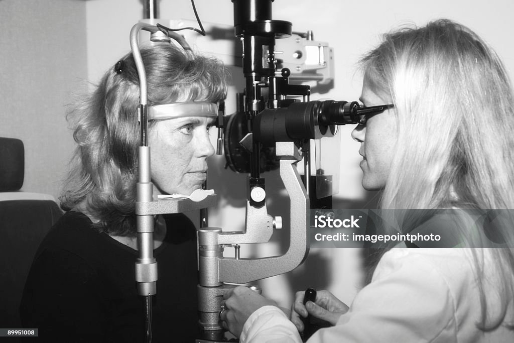 Ophthalmologist conducting an eye examination  Adult Stock Photo