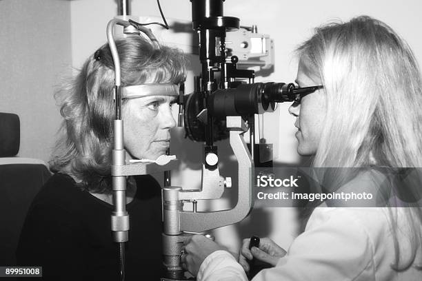 Ophthalmologist Conducting An Eye Examination Stock Photo - Download Image Now - Adult, Color Image, Eye Exam