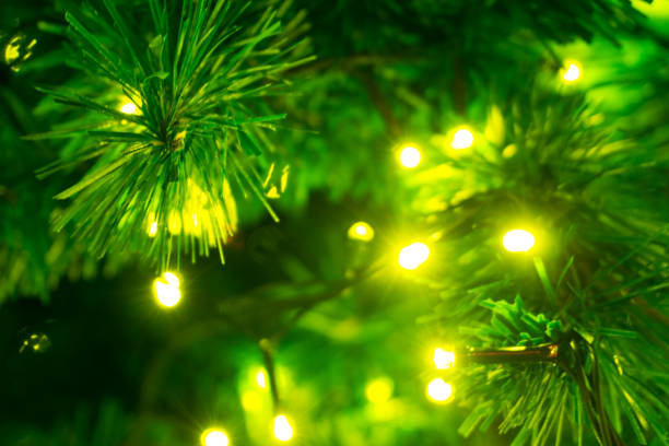 istock Christmas tree decorated with yellow lights 899515066