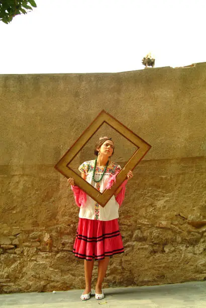 From the series "Living Portraits":Mexican woman holding a frame