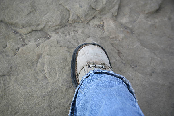 istock A Small Shoe Stepping Onto a Large Rock 89954819