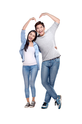 Portrait of asian couple making heart shape with hands posing isolated over white background