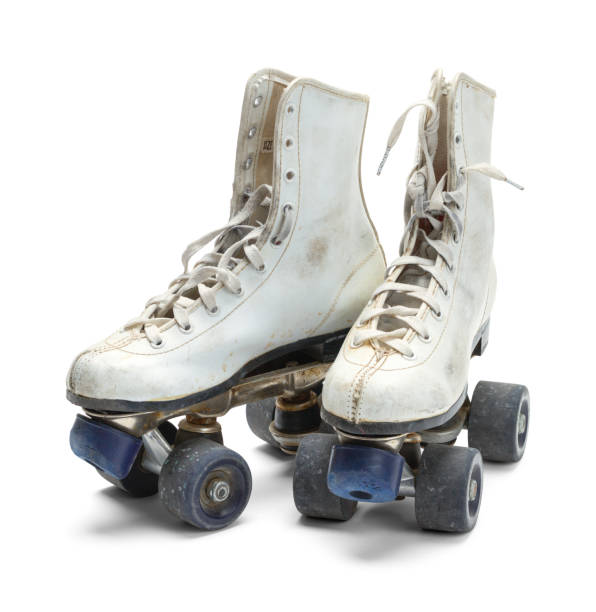 Old Roller Skates Two Worn Roller Skates Isolated on White Background. 1970 retro styled imagery stock pictures, royalty-free photos & images
