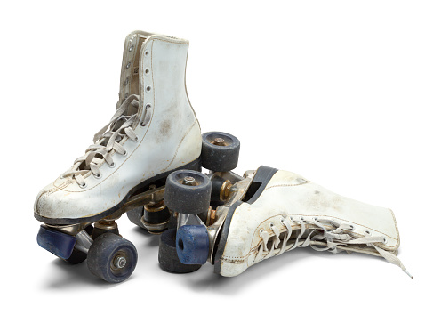 Two Worn Roller Skates Isolated on White Background.