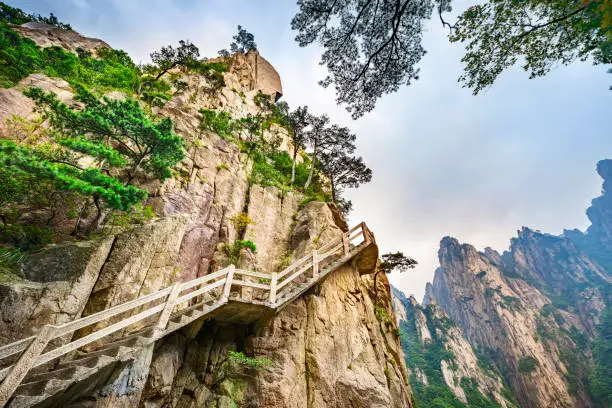 Tourist steps built on the cliffs of Huangshan (Yellow Mountains), a mountain range in Anhui province of China. It is a UNESCO World Heritage Site, and one of China's major tourist destinations.