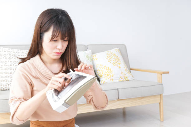 istock Young woman ironing her clothes 899566536