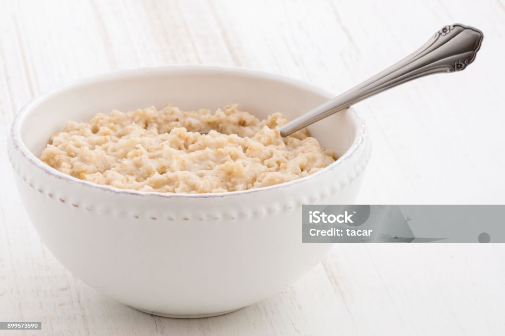 oatmeal breakfast Delicious nutritious and healthy fresh old fashioned oatmeal on antique wood table Porridge Stock Photo