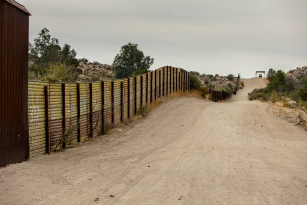 United States Border Wall with Mexico Jacumba, CA - NOVEMBER 27: United States international wall with Mexico and Border Patrol vehicle in the distance on November 27, 2017 in Jacumba, CA, USA. international border barrier stock pictures, royalty-free photos & images