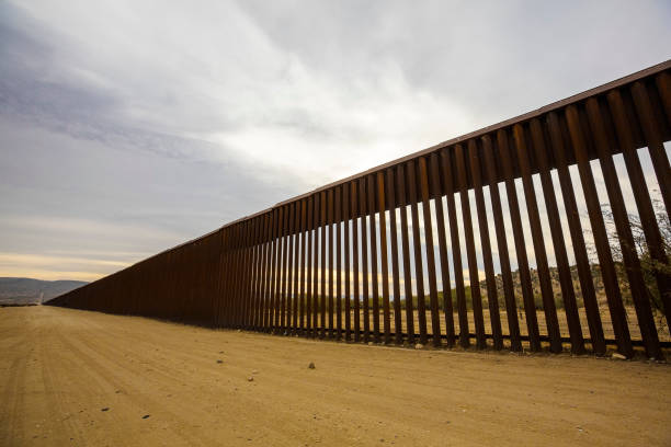 Long Section of United States Border Wall With Mexico Long section of the United States international border wall with Mexico international border barrier stock pictures, royalty-free photos & images