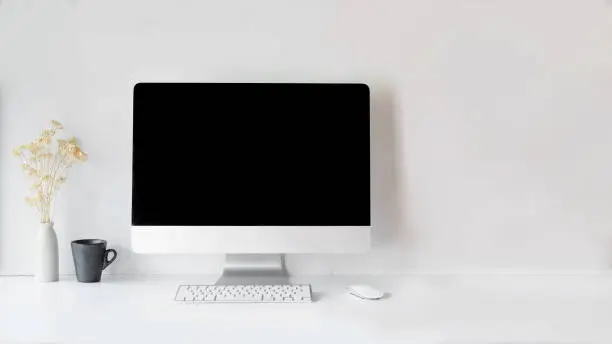 Photo of Modern clean workspace mockup with blank screen desktop computer.