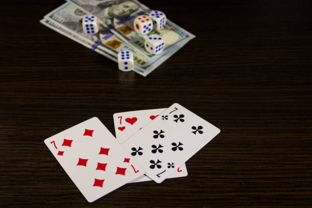istock Playing cards, dice and dollars on a table 899587990
