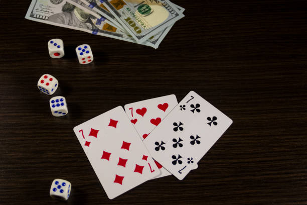 istock Playing cards, dice and dollars on a table 899587994