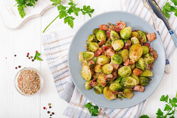 Brussels sprouts. Roasted Brussels sprouts with bacon. Delicious lunch. Flat lay. Top view stock photo