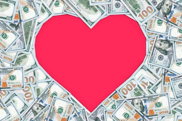 Heart shaped empty frame made with many 100 dollar banknotes