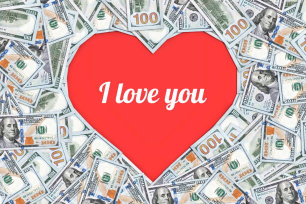 istock Heart shaped sign made with many 100 dollar banknotes isolated on white 899594180