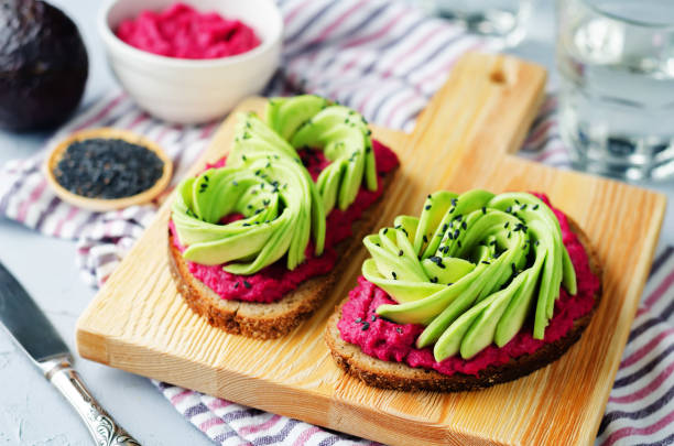 Healthy beet hummus avocado rye breakfast sandwiches