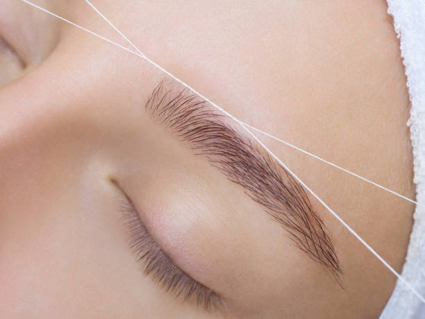 istock The make-up artist plucks her eyebrows with a thread close-up. 899602410