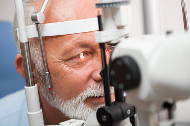 istock Senior man doing eye test with ,close up 899606206