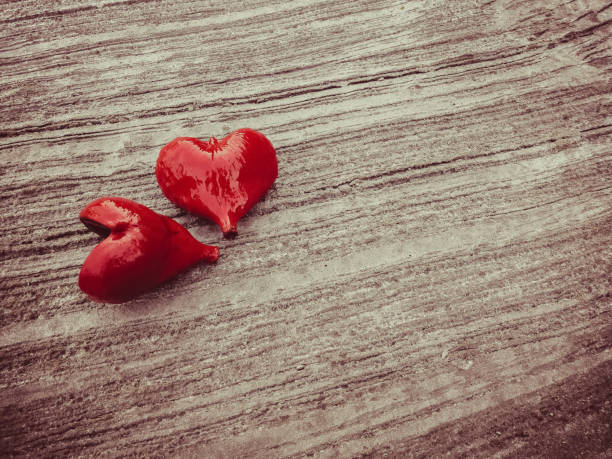 istock Red heart on concrete floor. 899606574